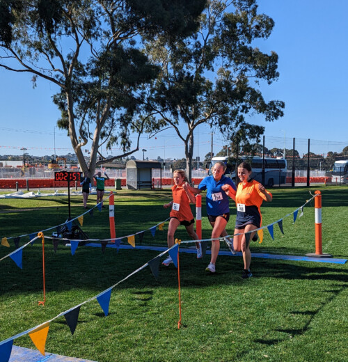 Greta, Ruby and Alice crossing the line at House Cross Country in 2023