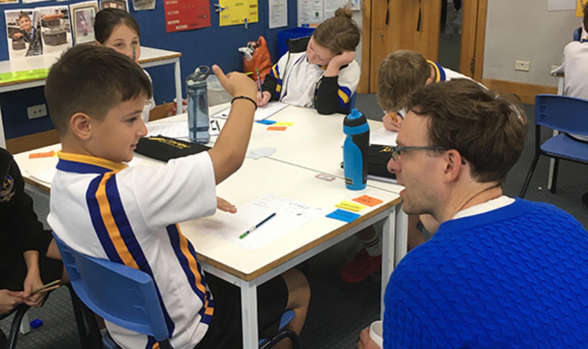 Author Andrew McDonald working with Year 3 student Atticus
